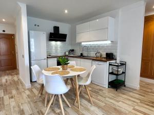 a kitchen with a table and chairs in a room at Casa Elsa with Free Parking in Los Abrigos