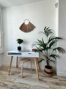 a white desk with a chair and a plant at Casa Elsa with Free Parking in Los Abrigos