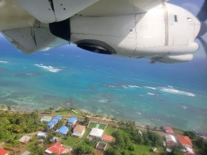 an aerial view of the ocean from an airplane at Ocean View in Big Corn Island