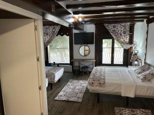 a bedroom with two beds and two windows at Vilador Beach Hotel in Masnou