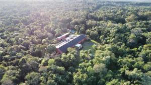 an aerial view of a barn in the middle of a forest at Momora distrito selva in Santa Ana