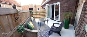 a patio with two chairs and a table at Anna's Zusje Boetiekhotel in Harlingen