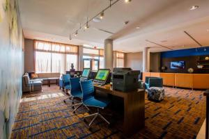 an office with a desk with a computer and chairs at Courtyard by Marriott Jackson Airport/Pearl in Pearl