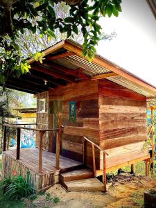 a wooden out house with a deck in the yard at Konsenda San Blas in Chepo