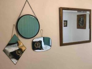 a mirror and some pillows on a wall at Richard III Luxury apartment in Leicester