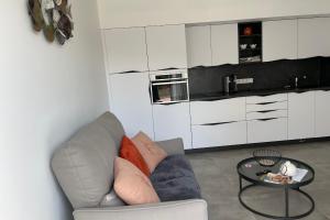 a living room with a couch and a table at Studio pour 2 personnes proche Canal du Midi - Ventenac en Minervois in Ventenac en Minervois