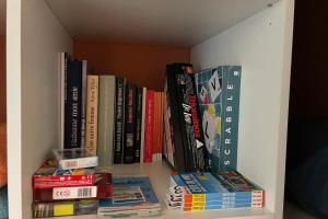 a book shelf filled with lots of books at Studio pour 2 personnes proche Canal du Midi - Ventenac en Minervois in Ventenac en Minervois