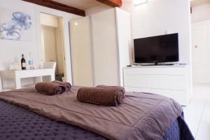 a bedroom with a bed with two pillows on it at SPQR Studios Valletta in Valletta