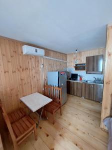 a kitchen with a table and chairs and a refrigerator at Ureki Beach in Ureki
