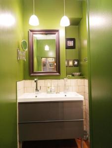 a bathroom with a sink and a mirror at A Vol D'Oiseau in Honfleur