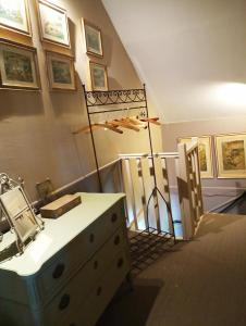 a room with a dresser and a staircase with a lamp at A Vol D'Oiseau in Honfleur