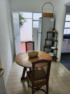 a kitchen with a table and chairs and a refrigerator at Casa Amplia en Pleno Centro Histórico in Salta