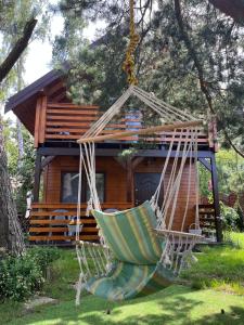 a hammock in front of a tree house at Tumiło in Dziwnów