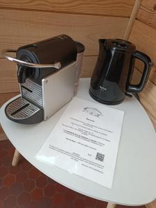 a table with a toaster and a coffee maker on it at L'Imprévu in Bourisp