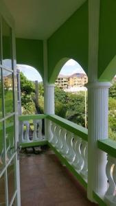 a green and white balcony with a view of a building at PINE VALLEY ESTATES 9b BALCONY VIEW TWO BEDROOM 2 BATHROOMS 