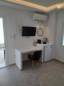 a white desk with a chair in a room at Sand rooms Antiparos in Antiparos