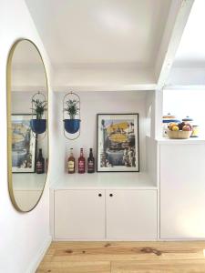 a white room with a mirror and a dresser at Art Cottage with oPorto View! in Vila Nova de Gaia