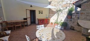 a patio with a table and chairs in a building at Vacation House Ivan Komiza in Komiža