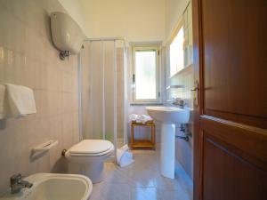 a bathroom with a sink and a toilet and a window at Residence Olimpo in Capo Vaticano +68 photos