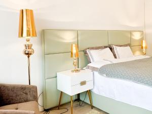 a bedroom with a bed and a lamp and a chair at Luxury suburb house - bright, quiet, beautiful in Vienna