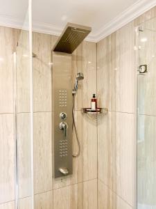 a shower with a shower head in a bathroom at Luxury suburb house - bright, quiet, beautiful in Vienna