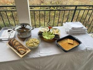 a table with some food and a pot and other foods at Guesthouse Tropojë e Vjeter in Tropojë