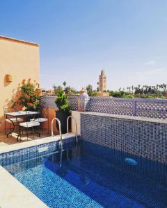 a swimming pool on the roof of a building at Riad Beni Sidel in Marrakesh