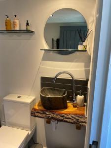 a bathroom with a sink and a mirror at The Bubble Hideaway - A Little Oasis near the Sea in Whitstable