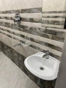 a bathroom with a white sink in a room at Variyar Service Apartments Unit B 1st Floor in Vellore +6 photos