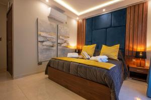 a bedroom with a large bed with yellow pillows at Domus Boutique Hotel in Rabat