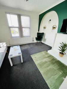 a living room with a couch and a chair at Stylish City Central Outskirts Sleeps 8 in Leeds