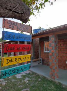 uma pilha de placas de rua em frente a uma casa em Casa de temporada 02 -Chalé Portal do Paraíso em Santo Amaro