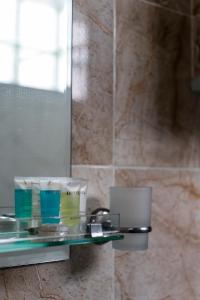 a glass shelf in a bathroom with a mirror at Kohi in Kazbegi