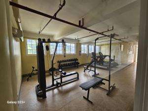 a gym with several tread machines in a room at AppleOne CondoTower1-1055 in Cebu City