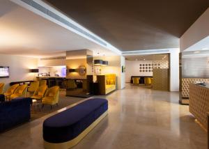 a lobby of a hotel with chairs and a bar at Lutecia Smart Design Hotel in Lisbon