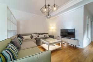 a living room with a couch and a tv at Apartament Delux Mountain Aparts in Świeradów-Zdrój