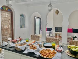 a table with food on it in a room at Dar Narjis in Asilah