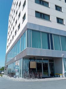 a building with bikes parked in front of it at Arche Hotel Wrocław Airport in Wrocław