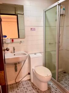 a bathroom with a toilet and a sink at Sota Residence in Pattaya South
