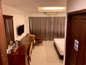 a hotel room with a bed and a room at Sota Residence in Pattaya South