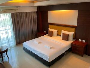 a bedroom with a large bed in a room at Sota Residence in Pattaya South