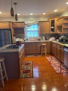 a kitchen with wooden cabinets and a counter top at Chateau la Mel in Mandeville