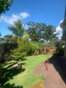 a basketball hoop in a yard with trees at Chateau la Mel in Mandeville