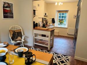 a kitchen with a table and a desk in a room at 5 Castle Hill in Lancaster