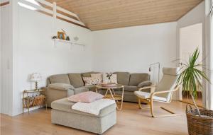 a living room with a couch and a table at Stunning Home In Børkop in Børkop