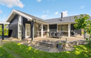 a house with a large deck in front of it at Stunning Home In Børkop in Børkop +20 photos