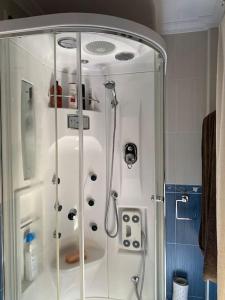 a shower with a glass door in a bathroom at Casa en Cangas - Playa y casco urbano in Cangas de Morrazo