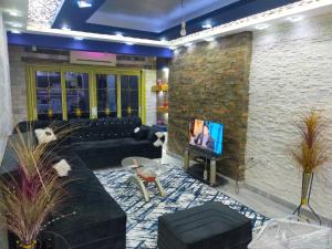 a living room with a couch and a tv at شقه فندقيه in Cairo
