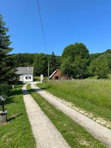 a dirt road in a field with a house and trees at Apartments Jezerce 28 in Jezerce