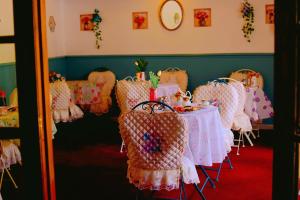 a dining room with a table with chairs with dolls on it at The Evergreen Inn in Banbury